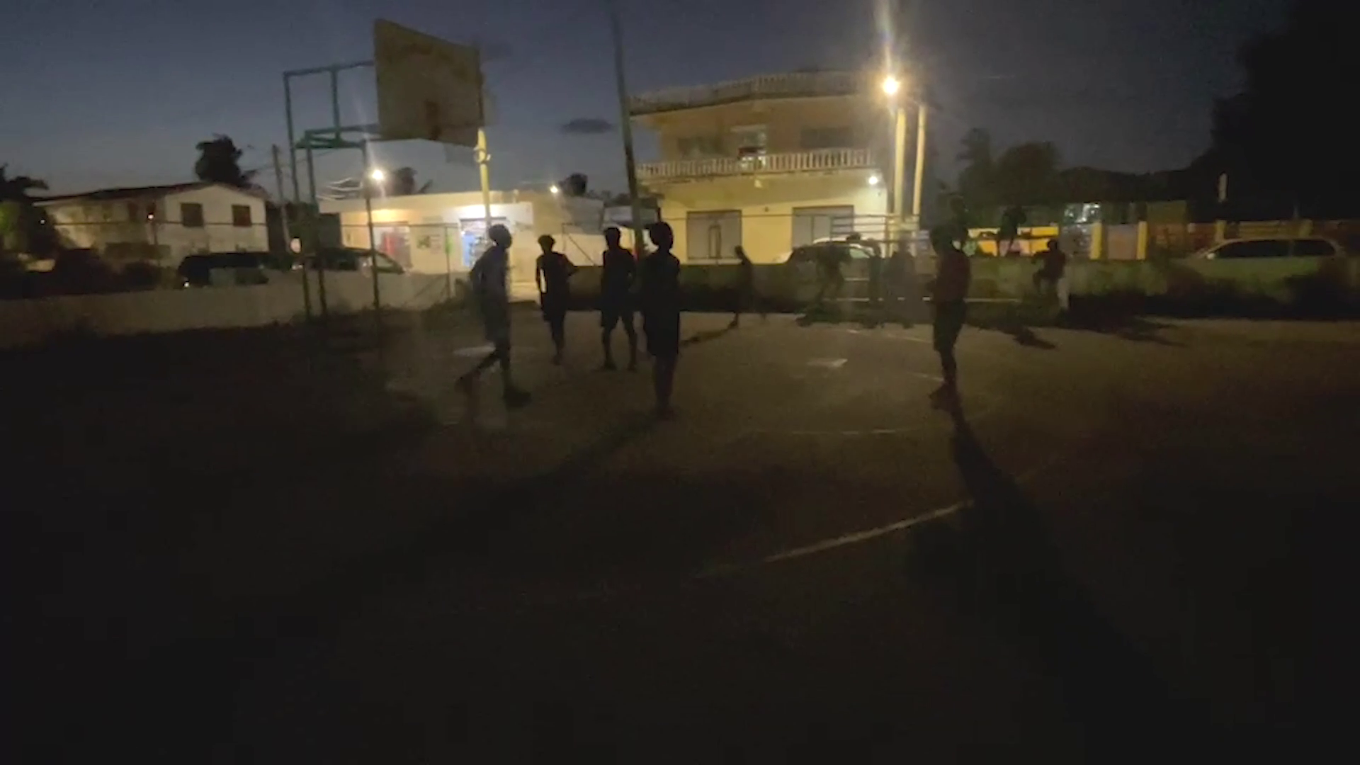 A basketball court, a ball and a group of young men determined to make the best of what they have.